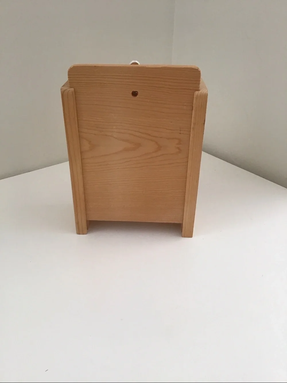 Handmade wooden cabinet holding a small wooden Nativity set
